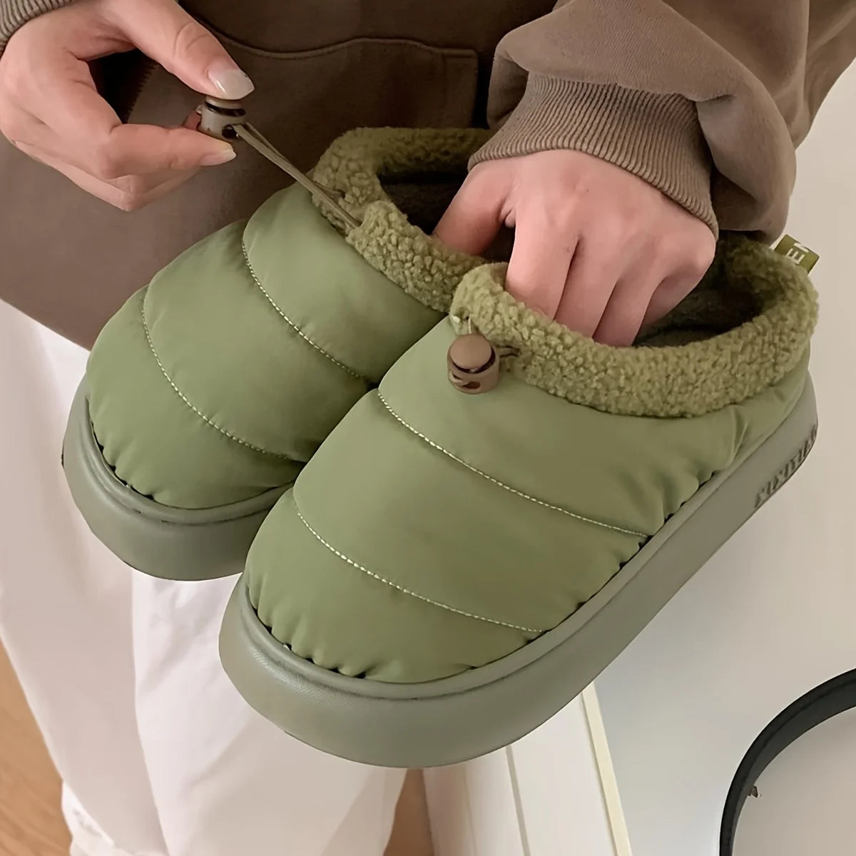 Cozy fuzzy winter slippers for women and men with soft EVA sole warm fabric lining indoor outdoor use casual style drawstring